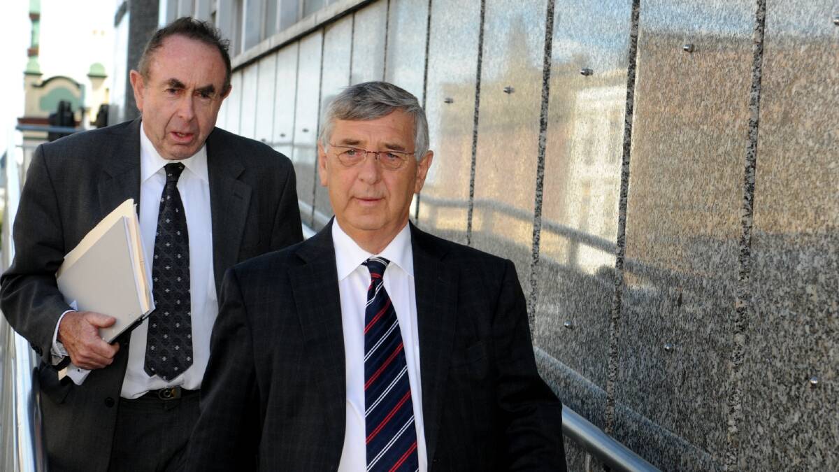 ‘Tasmania needs a pulp mill and needs an industry to employ its people’ . . . Former Gunns executive chairman John Gay, right, leaves a court in December. Photo: Geoff Robson 