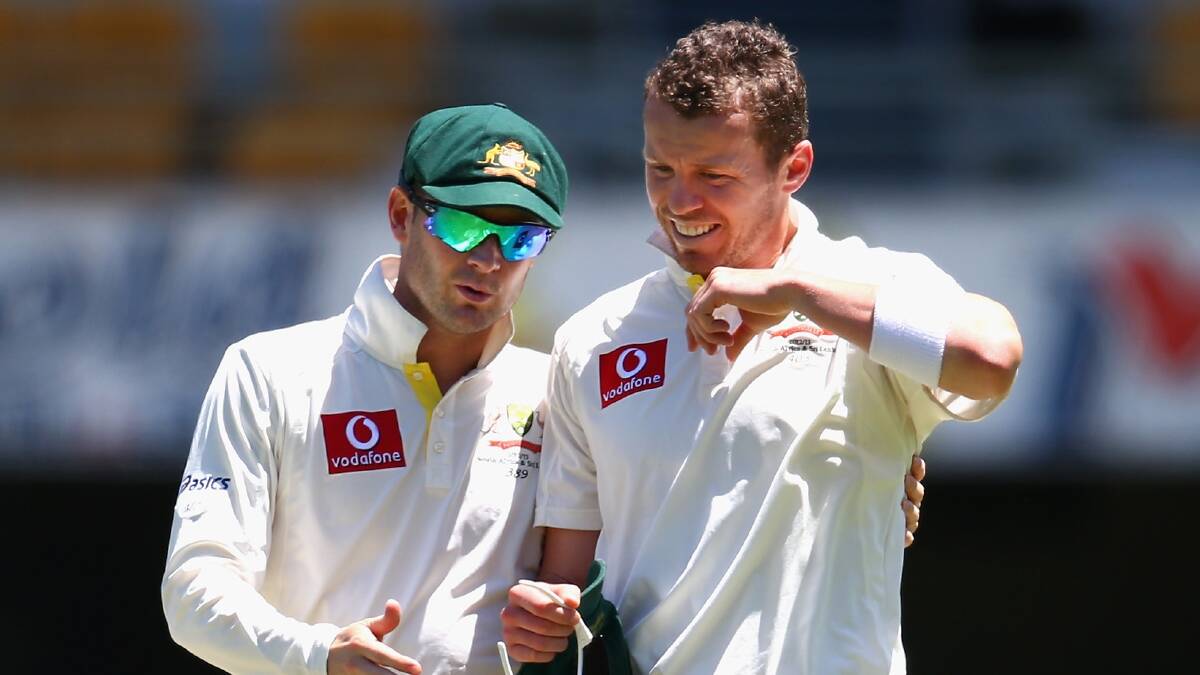 Australian captain Michael Clarke talks tactics with bowler Peter Siddle yesterday. Picture: Getty Images