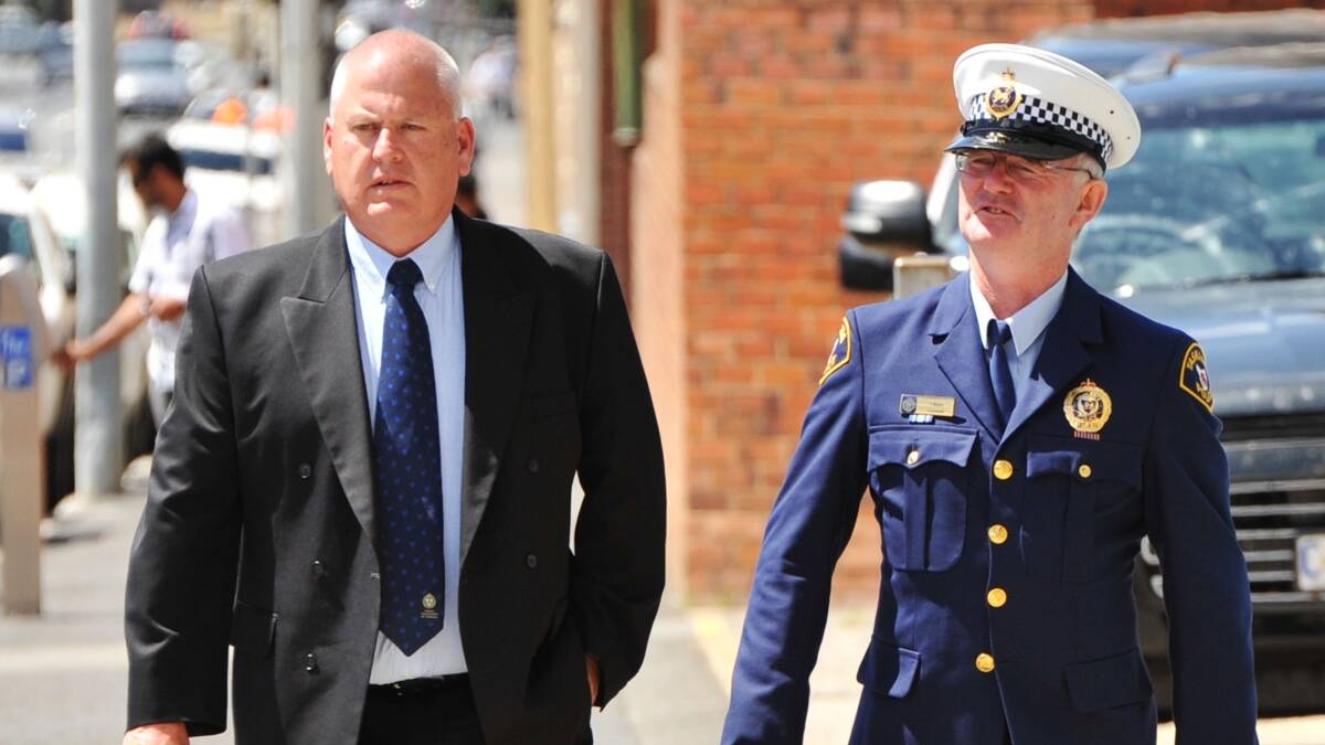 Tasmania Police Association president Pat Allen with Constable Ian Blake on their way to the coronial inquest in Launceston yesterday. Photo: Scott Gelston