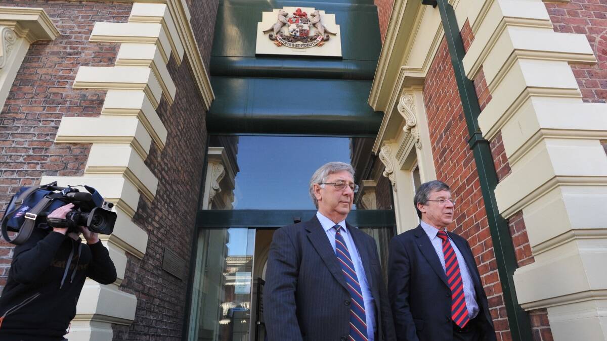 John Gay and his lawyer leave the Supreme Court in Launceston this morning after he was fined $50,000 for insider trading. Photo: Scott Gelston