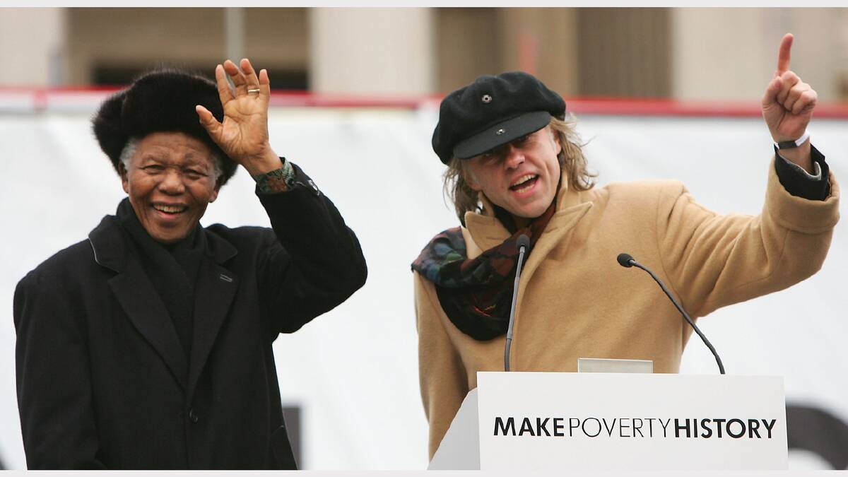  Former South African President Nelson Mandela (L) waves to the crowd with musician and campaigner Bob Geldof before making a speech endorsing the 'Make Poverty History' campaign during a mass rally in Trafalgar Square on February 3, 2005 in London, England.