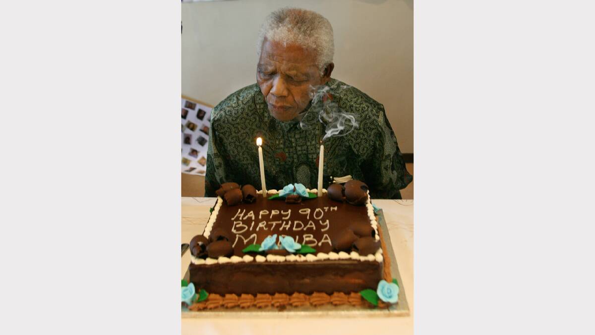  In this handout from Nelson Mandela Foundation, former South African president and Nobel peace prize laureate Nelson Mandela blows out the candles on his birthday cake received from the staff in honour his 90th birthday, at the Nelson Mandela Foundation August 5, 2008  in Houghton, Johannesburg