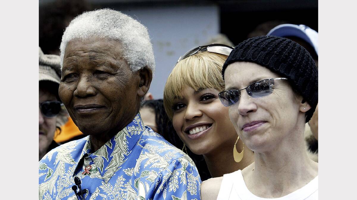 Nelson Mandela (L), singer Beyonce Knowles (C) and singer Annie Lennox  (L) after a press conference for the "46664 - Give One Minute of Your Life to Aids" concert on November 28, 2003 on Robben Island, off the coast of Cape Town, South Africa. 