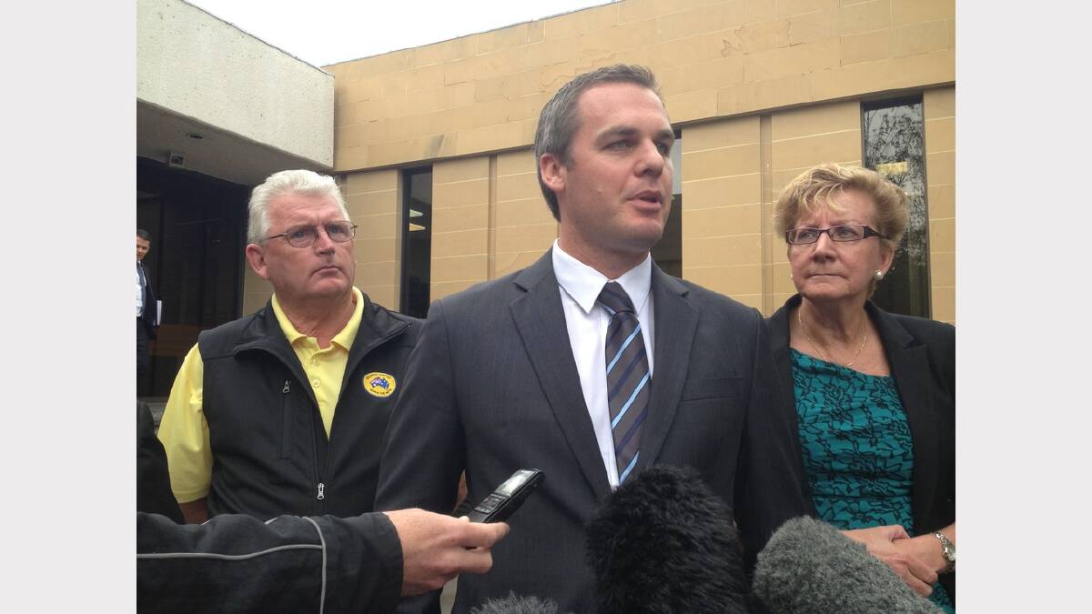 Palmer United Party state secretary James McDonald (centre) addresses the media outside court this morning, alongside PUP candidate Barbara Etter (right).