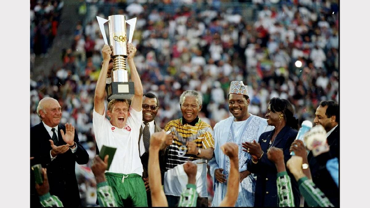 3 Feb 1996:  Neil Touey of South Africa lifts the African nations Cup with Nelson Mandela on his right hand side after the African Nations Cup final match against Tunisia played in South Africa.  The match finished in a 2-0 win for South Africa.   Mandatory Credit: Mark Thompson /Allsport	