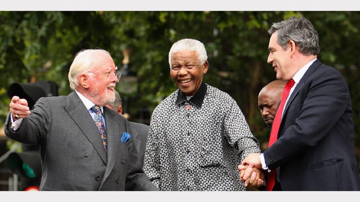 Lord Attenborough, and British Prime Minister assist ex-South African President Nelson Mandela to the podium during  a statue unveiling ceremony in his honour at Parliament Square on August 29, 2007 in London, England.