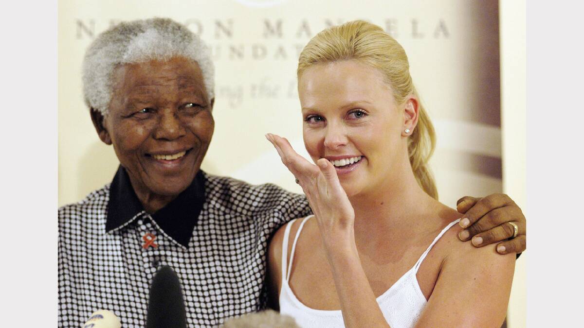 Oscar winning Actress Charlize Theron wipes away tears as she meets former South African President Nelson Mandela at Mandela House following her Academy Awards success, on March 11, 2004 in Johannesburg, South Africa