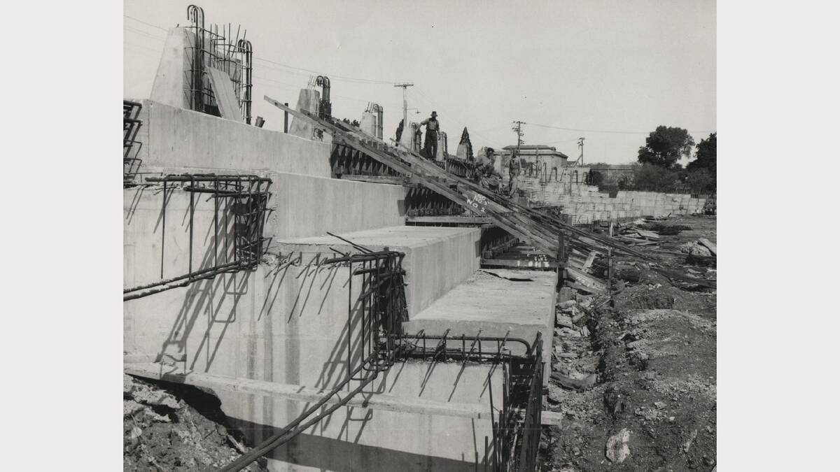 Construction of the concrete wall of the flood protection wall at Royal Park. Photo: January 1964.