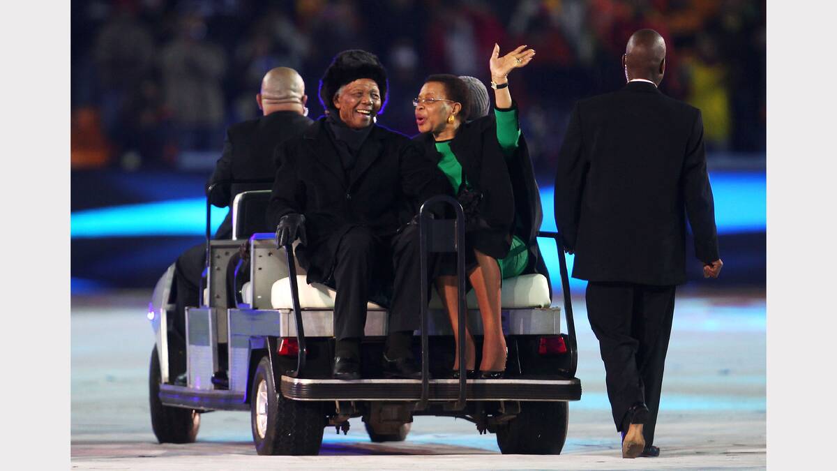 Former President of South Africa Nelson Mandela and his wife Graca Machel smile and wave to the crowd ahead of the 2010 FIFA World Cup South Africa Final match between Netherlands and Spain at Soccer City Stadium on July 11, 2010 in Johannesburg, South Africa. 