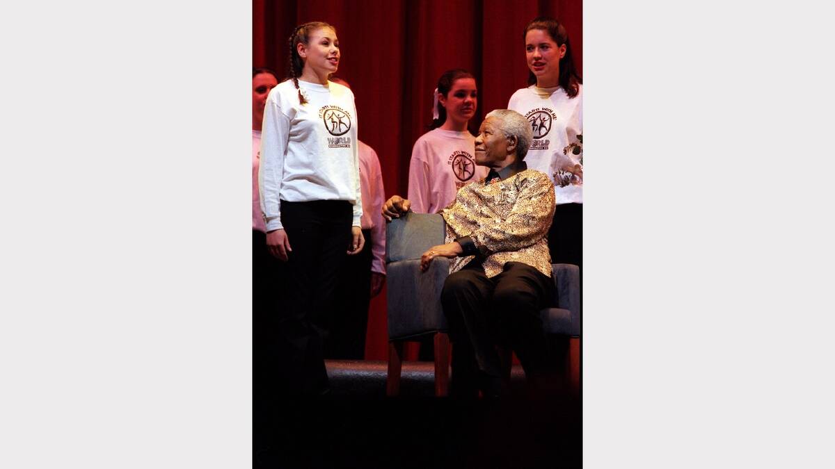  Nelson Mandela listens to the Australian Girls Choir during the World Reconciliation Day Concert at the Colonial Stadium September 8, 2000 in Melbourne, Australia. (Photo by Hamish Blair/Liaison)