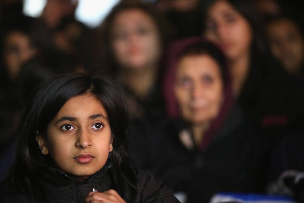 A young girl watches the entertainment on stage during the Hindu festival of Diwali on November 13, 2012 in Leicester, United Kingdom. Photo by Christopher Furlong/Getty Images