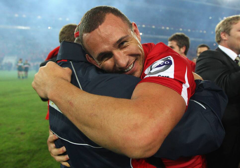 Quade Cooper of the Reds celebrates with coach Ewen McKenzie after winning the 2011 Super Rugby Grand Final match between the Reds and the Crusaders at Suncorp Stadium on July 9, 2011 in Brisbane, Australia. Photo by Cameron Spencer/Getty Images