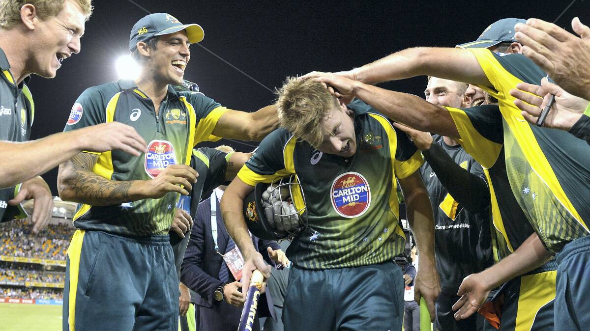 James Faulkner is cheered off by teammates after hitting the winning runs in the second game of the One Day International Series between Australia and England. Picture: GETTY IMAGES