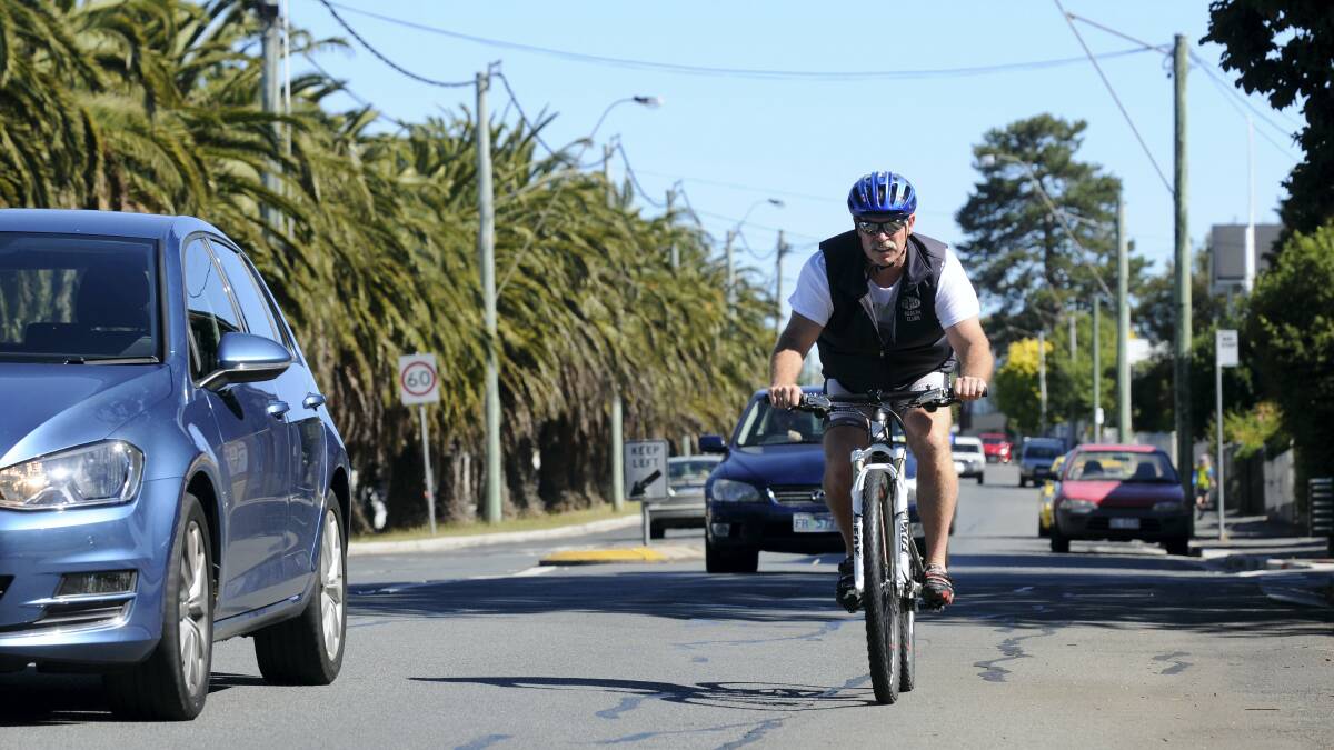 Personal trainer Mark Connelley rides along High Street in Launceston. Picture: PAUL SCAMBLER