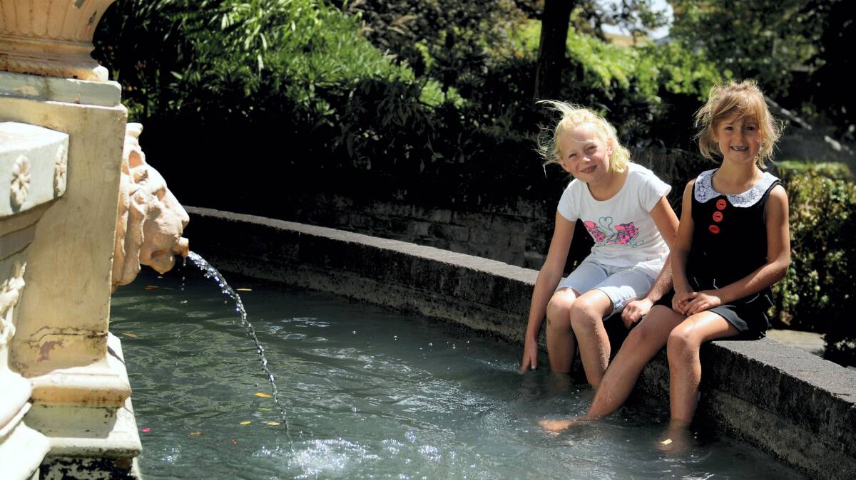 Esther, 7, and Saskia Dingemanse, 5, of St Leonards, cool down in Launceston's City Park. Picture: GEOFF ROBSON