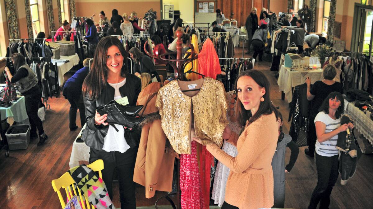 My Closet Market organisers Naomi Pugh and Claire Vos inspect items for sale at Launceston's Windmill Hill Hall.  Picture: PHILLIP BIGGS