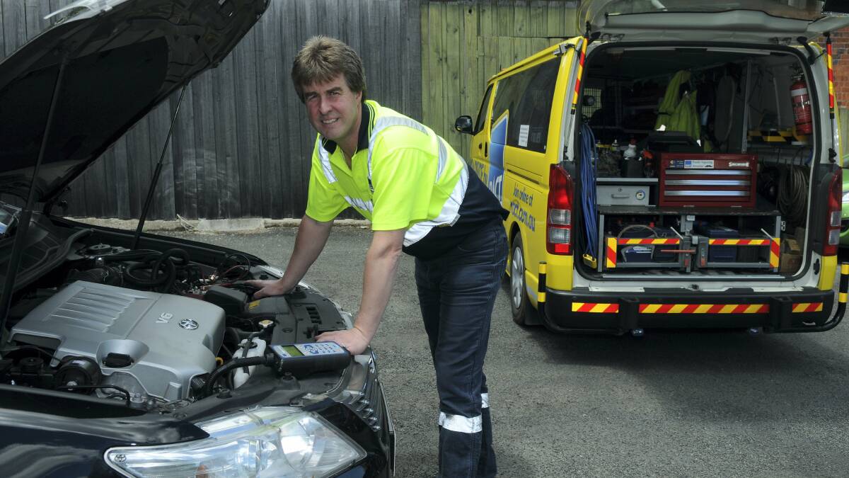 RACT service mechanic Brendan Hummerstone checks a vehicle ahead of the holiday season. Picture: PAUL SCAMBLER