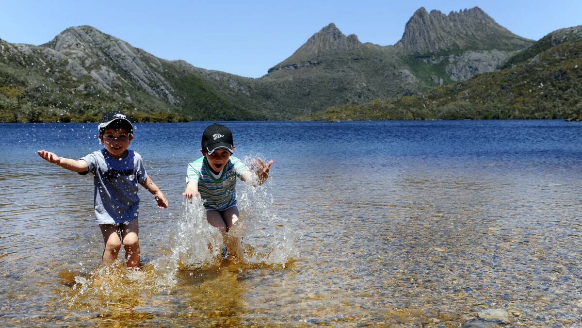 Romano Monteverde, 3, and brother Dante, 5, of Brisbane, play in the cool water of Dove Lake.  Picture: WILL SWAN