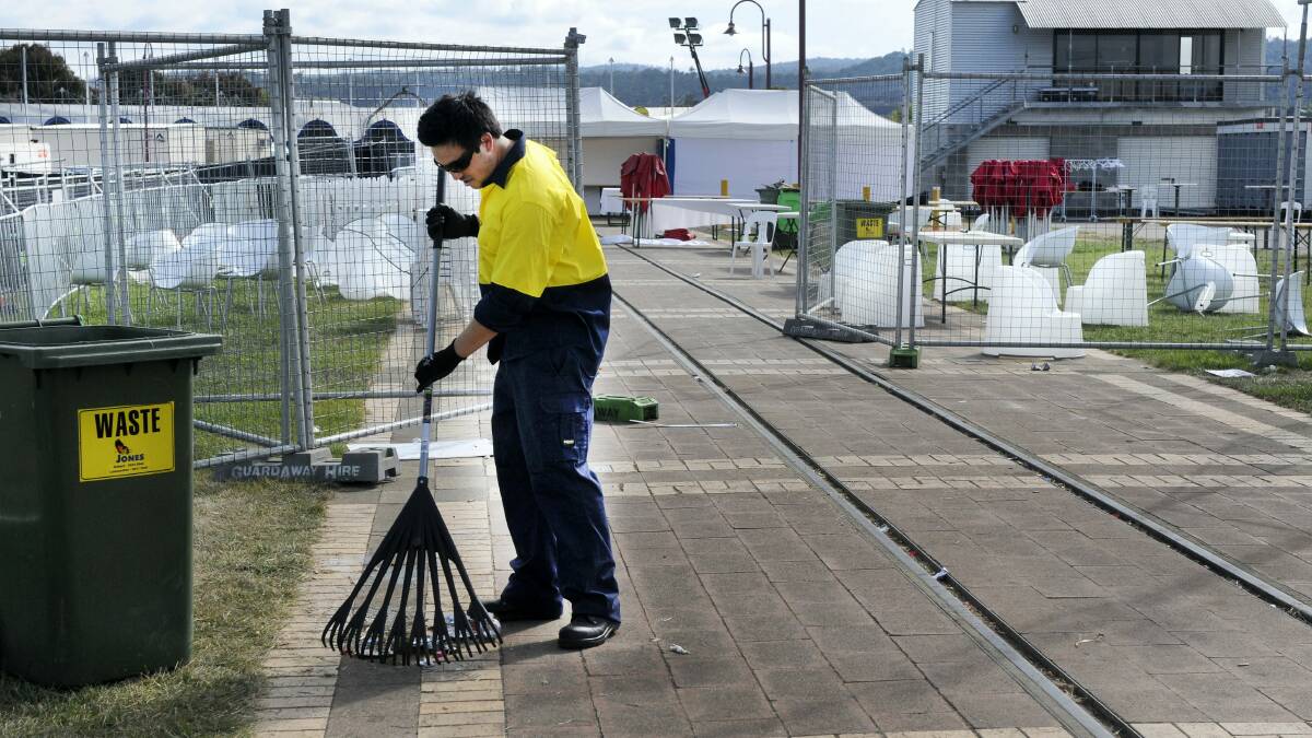 Veolia contractor Luke Laycock cleans up rubbish from Sunday's Breath of Life music festival.  Picture: PAUL SCAMBLER