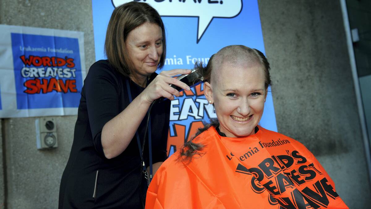 LGH physicist Nikki Caswell shaves the Holman Clinic's Sally Trotter. Picture: GEOFF ROBSON