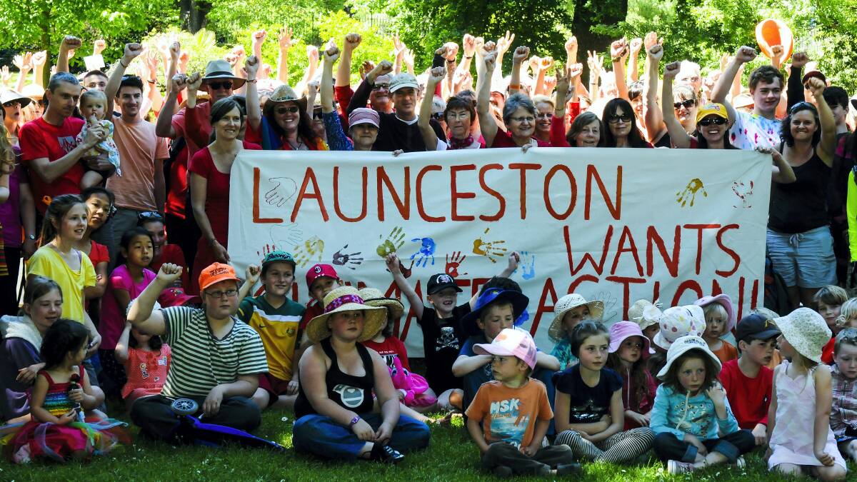 Members of the crowd in Launceston's City Park send their message on climate change.   Picture: NEIL RICHARDSON