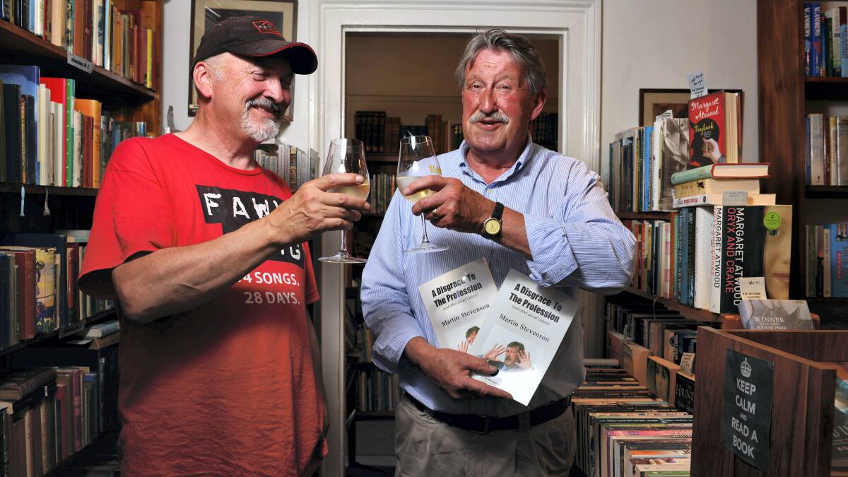  Editor Steve Davis and author Martin Stevenson toast Stevenson's new book, A Disgrace to the Profession. Picture: SCOTT GELSTON