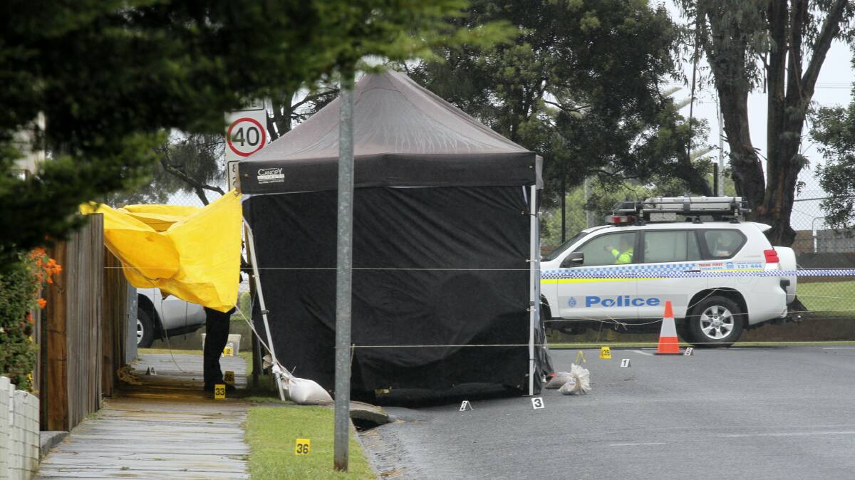 Forensic services at the scene of a fire-bombing attack on a police officer's car in Devonport.