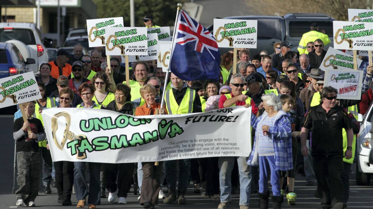 Protesters march through Smithton in support of Ta Ann and against activists who halted production at its mill.