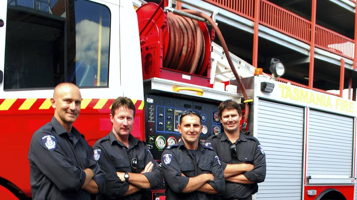 Launceston Fire Brigade firefighters Stuart Tuthill, Jeremy Patterson, Mark Ciantar and Paul Morrison in front of a new high-capacity heavy pumper.