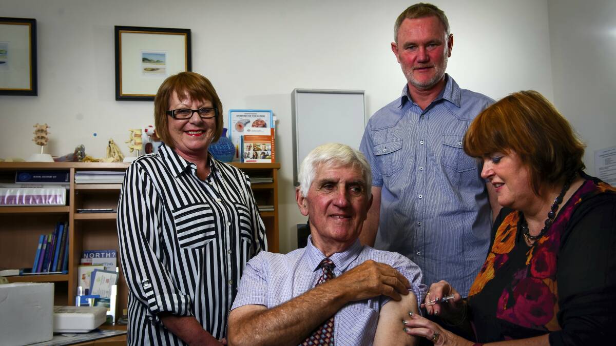 Caledonian Medical Service's   Leanne Jones gives a  flu shot to Graeme Snooks, of Newstead, watched by  Sue Pennington and Launceston   Mayor Albert van Zetten, who also received  shots. Picture: PHILLIP BIGGS