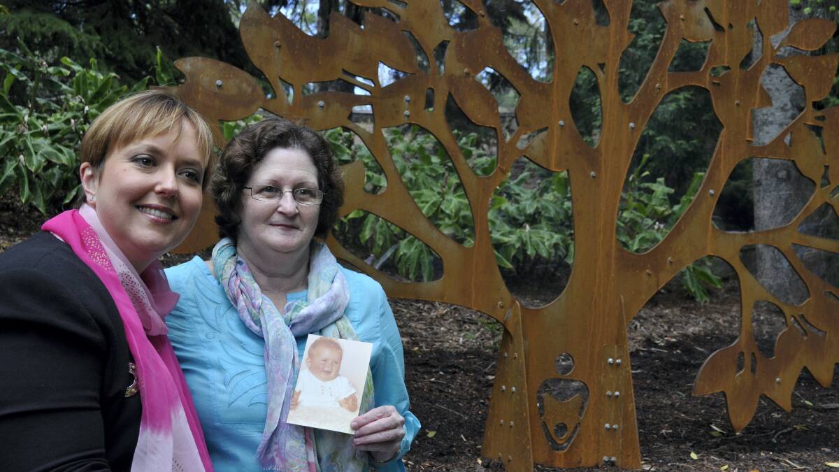 Premier Lara Giddings and Carolyn McGrath, whose daughter Cristy was taken from her in 1974, at a new memorial in the Royal Botanical Gardens in Hobart for victims of forced adoption.