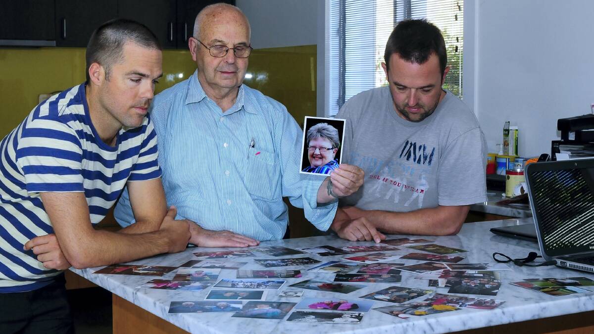 Son Paul, husband Russell and son Wayne with photographs of Pauline Watson. Picture: NEIL RICHARDSON