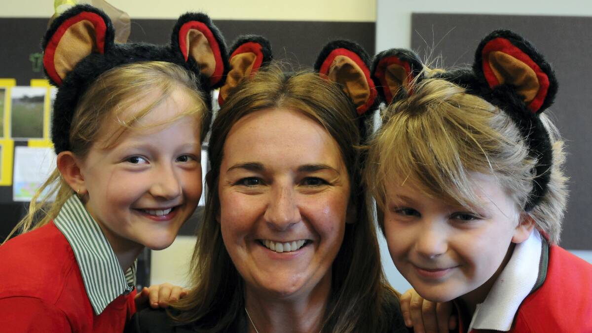 Save the Tasmanian Devil Appeal manager Rebecca Cuthill is flanked by East Launceston Primary School pupils Amelia Reynolds and Zen Mercer. Picture: PAUL SCAMBLER