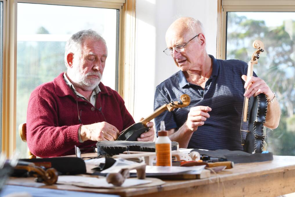 Roger Bodley and Chris Henderson work away at their new kelp violins.