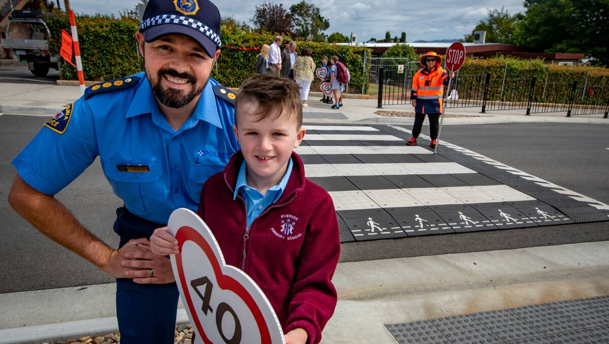 Acting Inspector Stuart Greenwood with Oliver Adlard, 6, at the Road crossing at Cleghorn avenue, near Riverside Primary school. Picture by Paul Scambler 