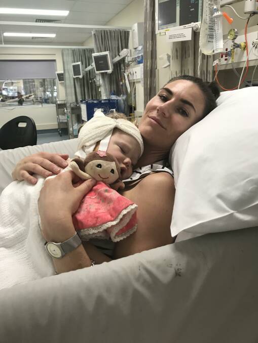 SUPPORT: Steph Mountney with her daughter Frankie in a Sydney hospital after Frankies cohclear implant surgery. Picture: Supplied