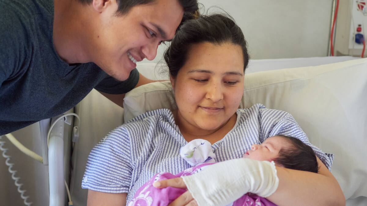 Brand new parents, Ajay and Dristy K C Thapa with their Christmas Day baby. Picture by Rod Thompson 