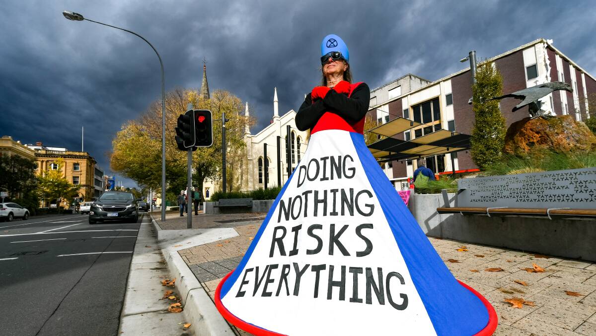 ACTION: A demonstrator outside Civic Square for the Climate Rally. Picture: Phillip Biggs