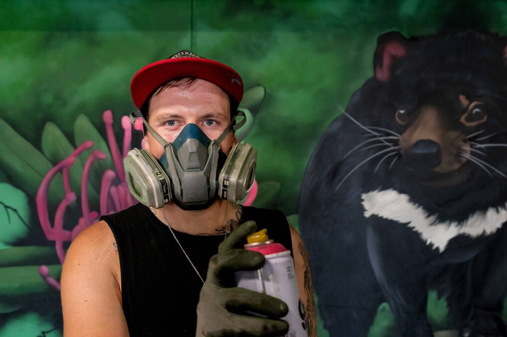 Street artist, KreamArt James Cowan is helping Launceston Medical Centre to combat a graffiti problem in their carpark by spray painting a new mural. Pictures by Phillip Biggs