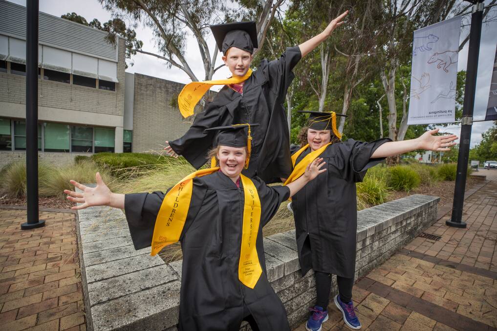 Waverley Primary School students Charlotte Field, Lucas Cuthbertson and Melodie Dent celebrate after their graduation from the Childrens University in Launceston. Picture by Richard Jupe