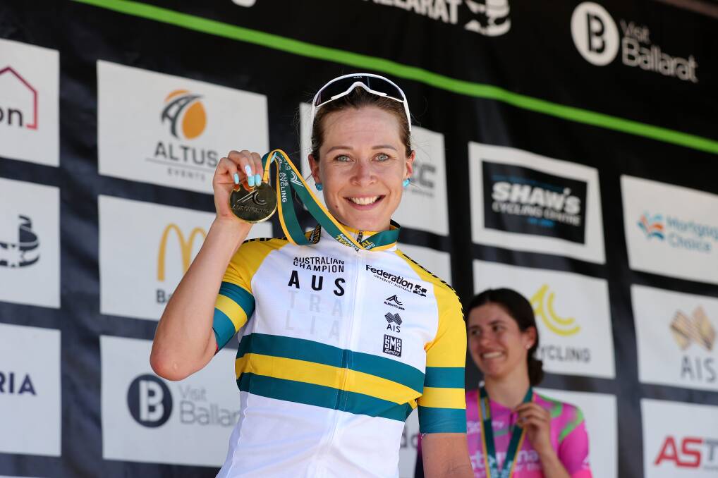 GOLDEN MOMENT: Frain lifts her road championship medal. Picture: Con Chronis