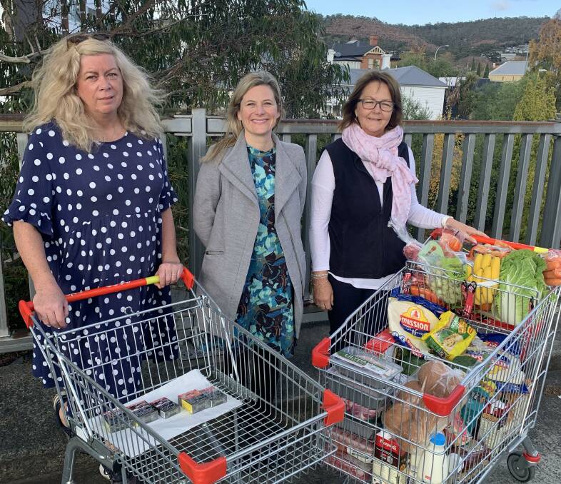 Quit Tasmania's Sue Hearn, Abby Smith, Wendy Atkinson showing what $253 can get someone at the supermarket for World No Tobacco Day. Picture supplied