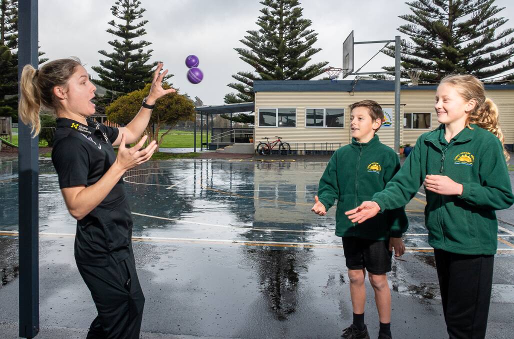 IN ACTION: Hobart Hurricanes WBBL star Nicola Carey visited Cooee Primary School on Monday, pictured with students Alec de Bomford, Year 5, and Laila Jones, Year 6. Picture: Simon Sturzaker