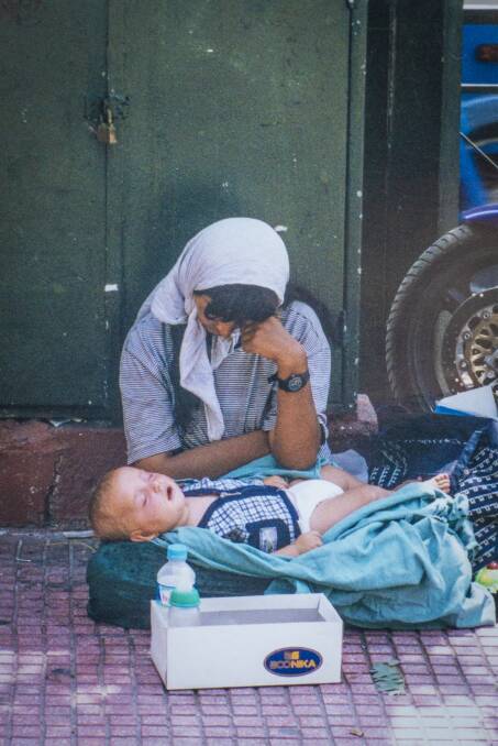 A mother and her baby begging on city streets