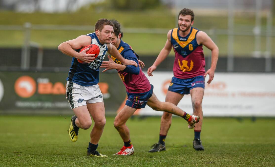 FINALS FEVER: Old Launcestonians Lochie Hanson attempts to break free of Old Scotch's Harrison Gee. Picture: Craig George 