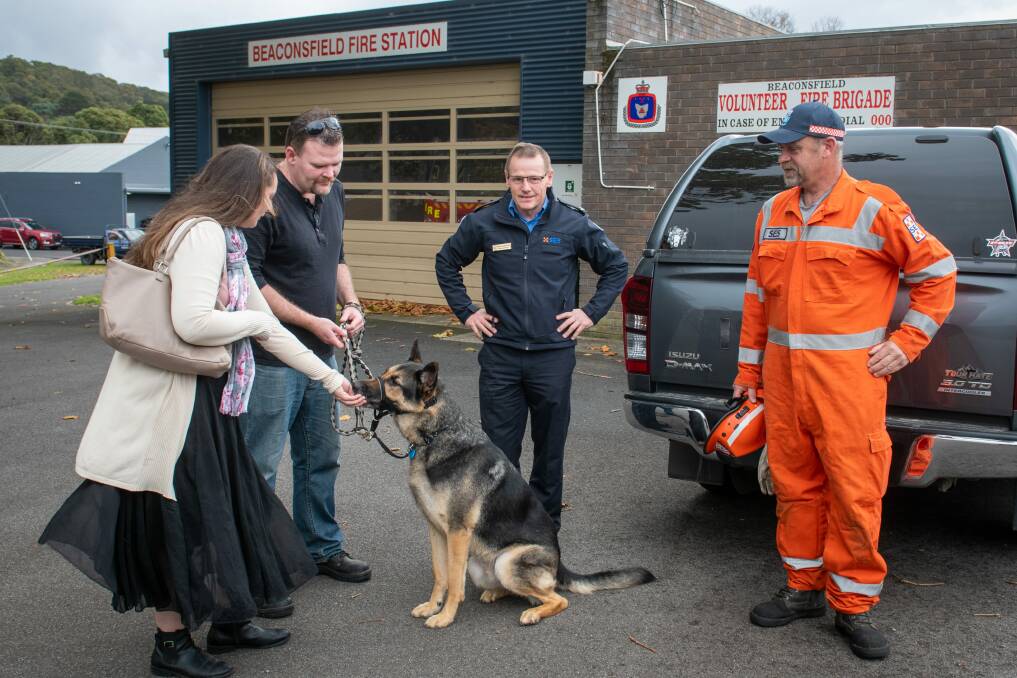 REUNITED: Bear reunited with owners Emma and Dan Rule along with SES regional planner Peter Rawlings and SES member Tony Britton. Picture: Paul Scambler