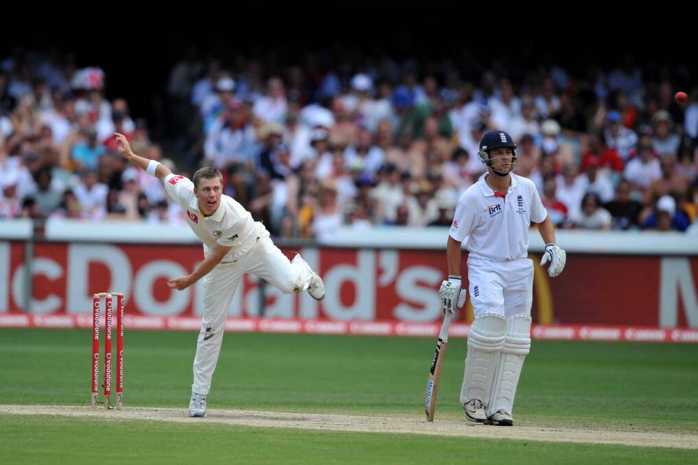 SPINNER: Xavier Doherty sends one down as Jonathan Trott watches on during the opening Ashes Test in 2010-11. Picture: Will Swan
