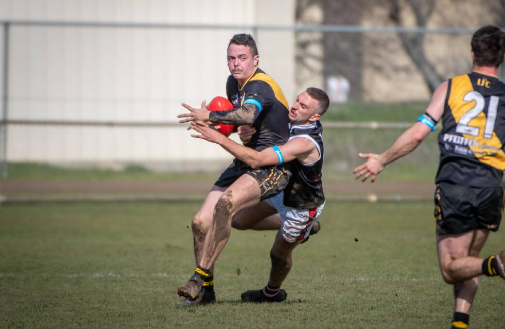 PRESSURE ON: Longford's Hamish Sytsma feels the pressure from George Town's Matthew McKinnon in their round 18 fixture. Picture: Paul Scambler 