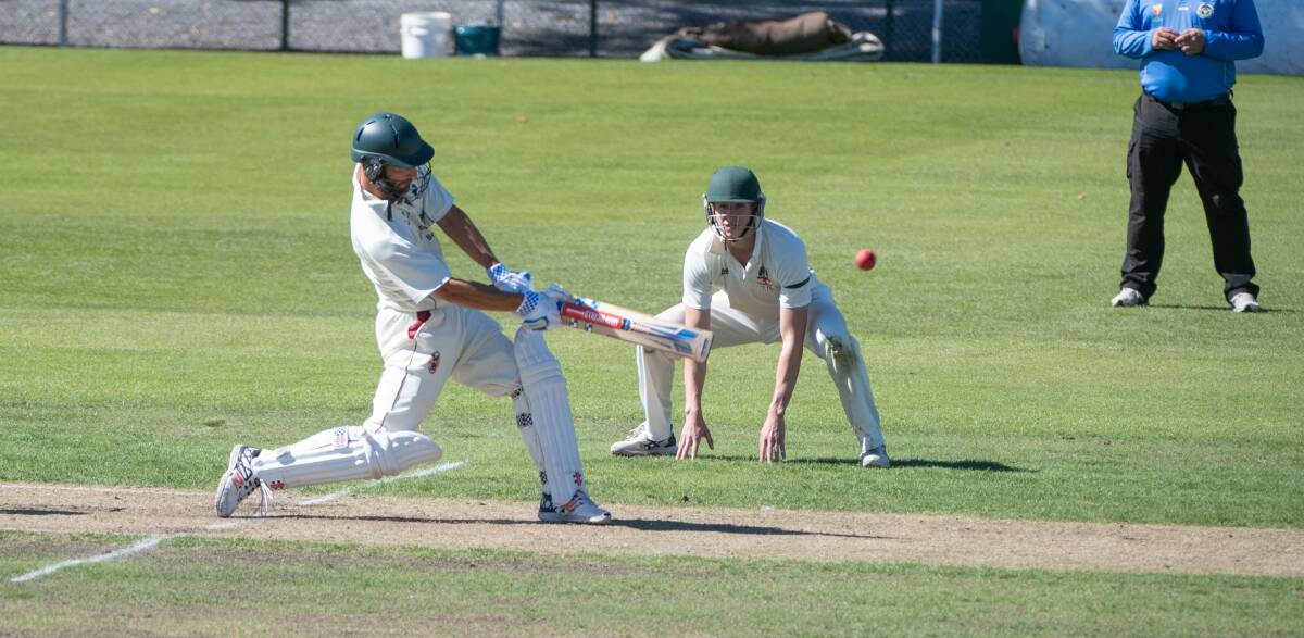 Jono Chapman launches one down the ground during his innings.