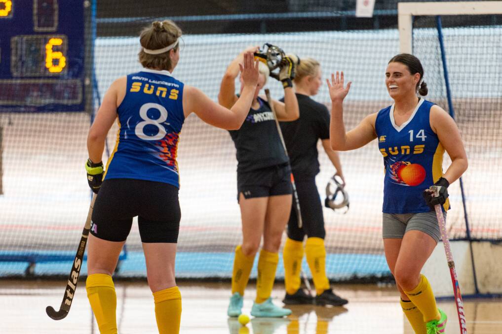 Nicole Symonds and Kira Trethewie celebrate a goal during the Festival of Indoor Hockey tournament.